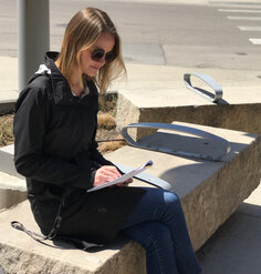 LAF Research Assistant Hannah LoPresto inventories P Street's site elements while seated on a limestone bench