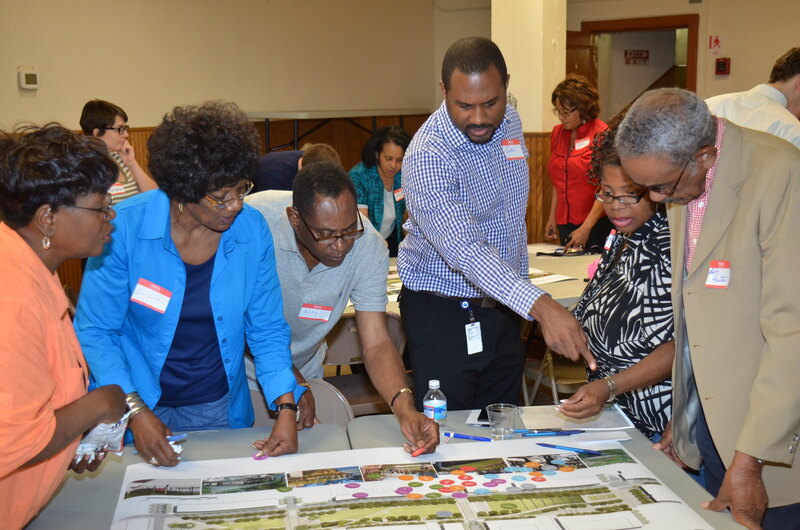 Individuals participating in a community outreach event for Eager Park