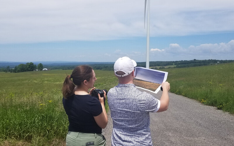 Meaghan Keefe and Aidan Ackerman compare a before photo to the site at the time of evaluation