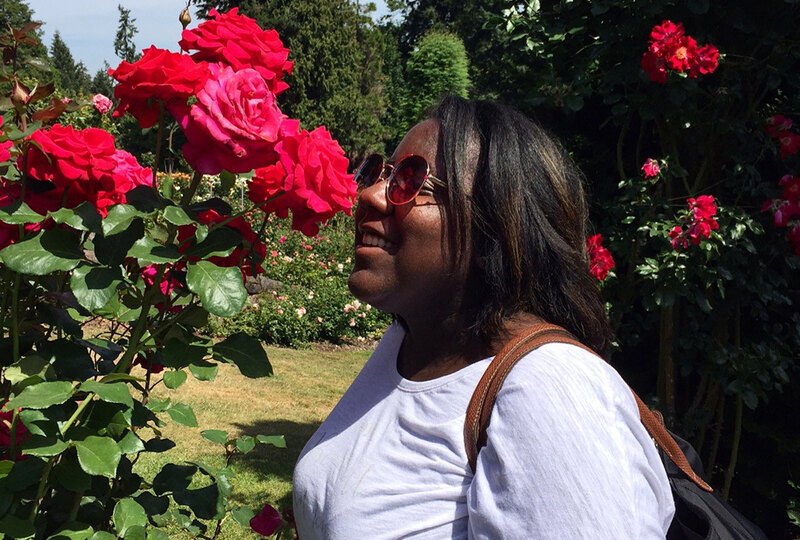 Jescelle smelling roses in a garden