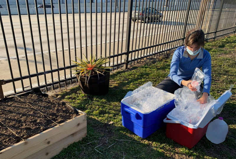 A team member conducts field work on a plot of land near the I-95 corridor in Philadephia