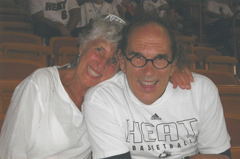 Jeanne and Joe Lalli smiling in the bleachers at a Miami Heat game