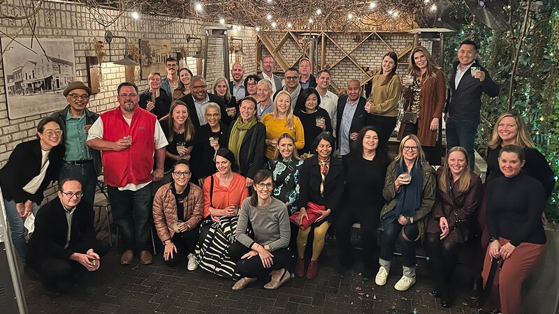 34 LAF board members and staff pose for a group photo in an outdoor courtyard