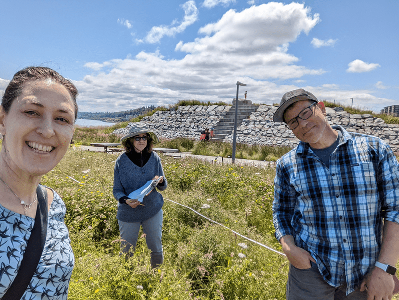 Researchers stand in front of a mound at Dune Peninsula. 