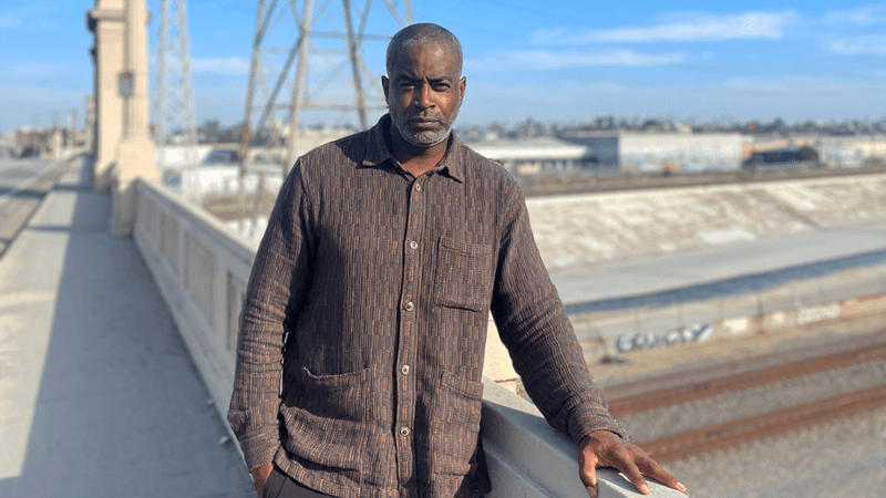 Anton Smith stands on a bridge in Los Angeles. 