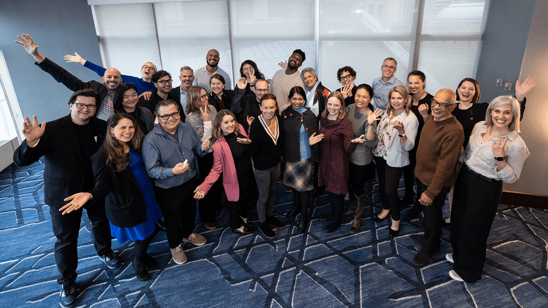 27 members of the LAF Board of Directors wave to the camera