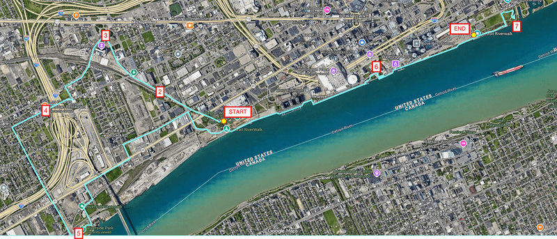 A map of Detroit along the Detroit River with a light blue line showing the bike route and numbered stops