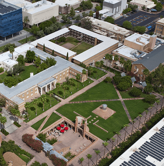 Aerial view of part of the Arizona State University campus showing the library, lawn, and solar-panel covered parking