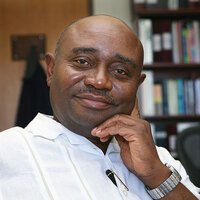 Forster Ndubisi sitting in an office with a bookshelf in the background