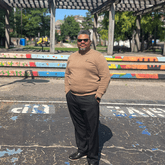 Johnny Macon stands on a basketball court.