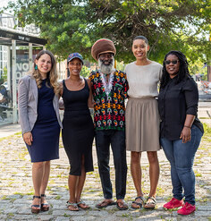 LAF Fellow Diana Fernandez poses on a cobblestone street with project partners