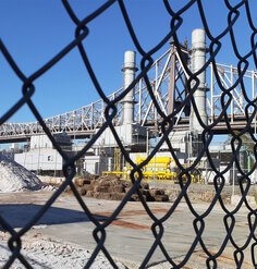 NYC peaker plant through chainlink fence.