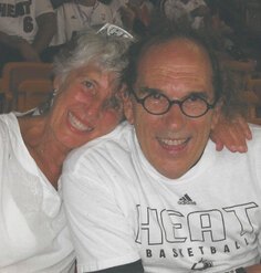 Jeanne and Joe Lalli smiling in the bleachers at a Miami Heat game