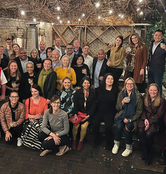 34 LAF board members and staff pose for a group photo in an outdoor courtyard