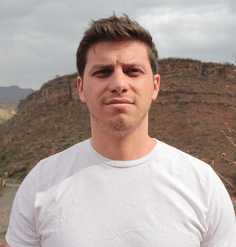 Rob Levinthal stands in front of a hill.